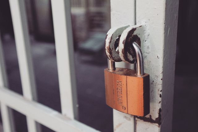 a padlock on a metal gate